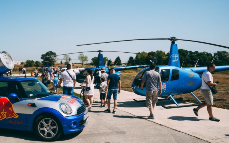 Visitors looking at helicopters on display at a World Helicopter Day open day