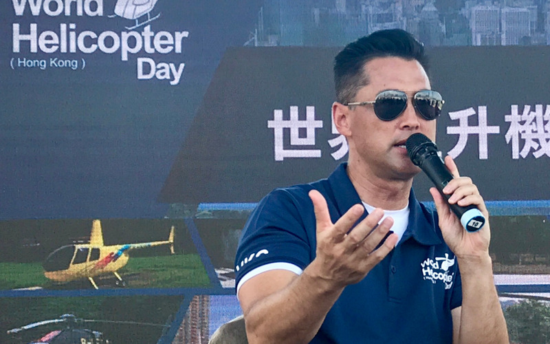 A speaker addressing the crowd at a World Helicopter Day event in Hong Kong
